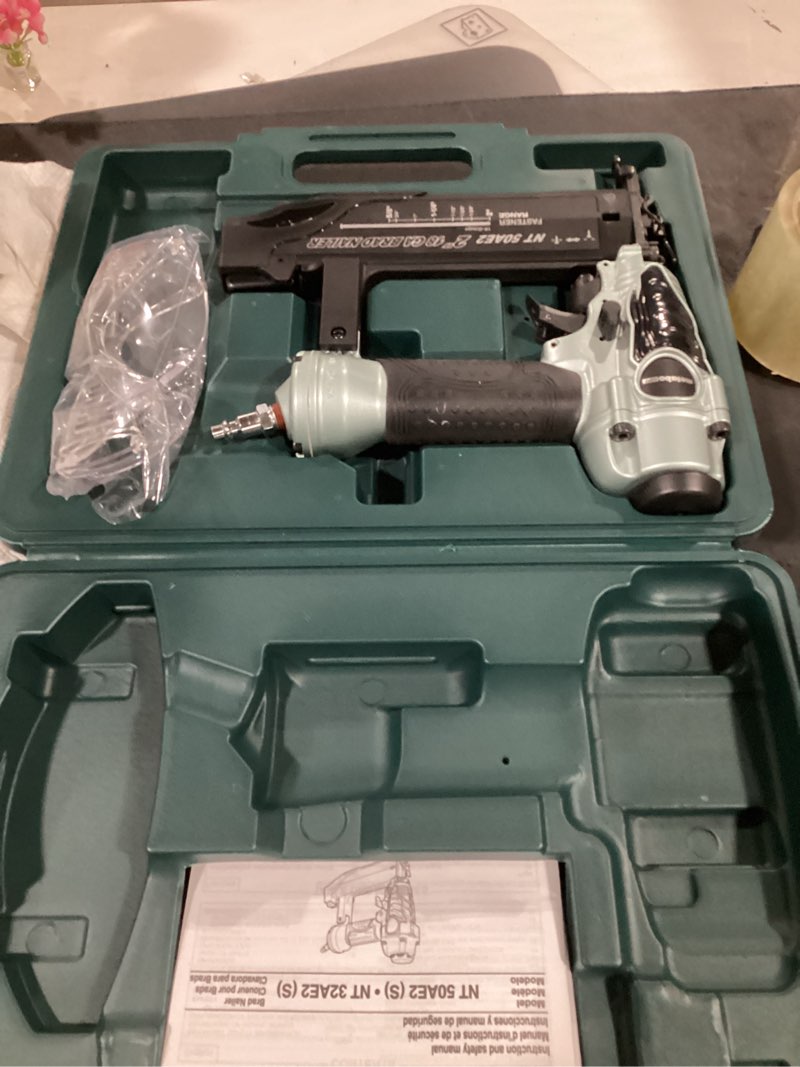 Condition photo showing As Is for metabo hpt brad nailer, pro-preferred lightweight pneumatic power nailer for precision trim work and furniture building, adjustable depth, 18 gauge, 5/8" up to 2" brad nails, nt50ae2 loveseat