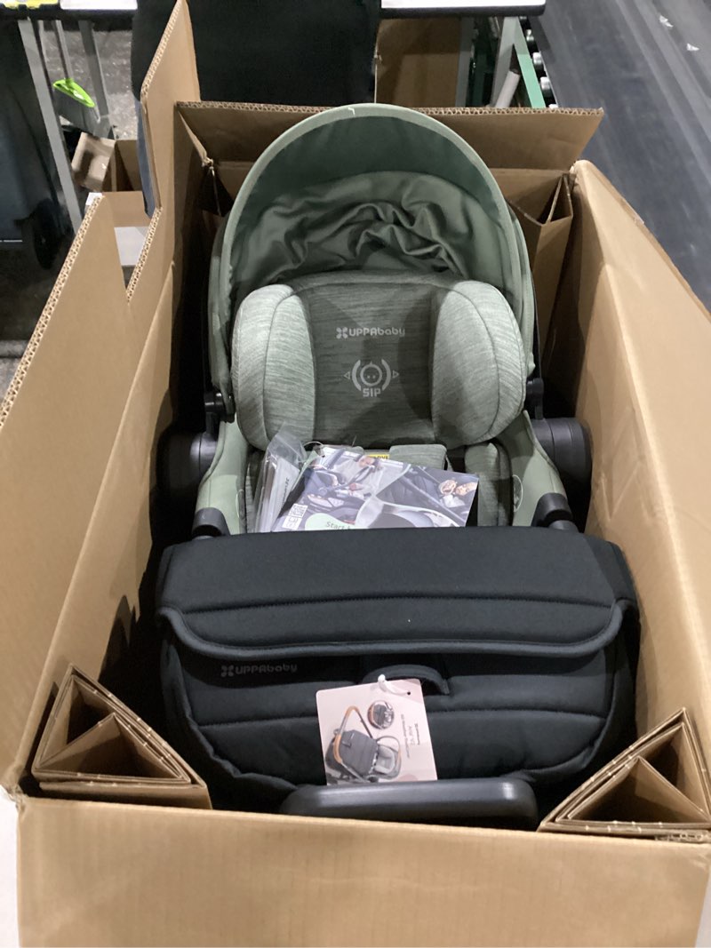 Condition photo showing New/Like New for uppababy aria v2 lightweight infant car seat - load leg + anti-rebound panel - infant insert + all-weather footcover included - direct stroller attachment - evelyn (green meadow) evelyn (meadow green)