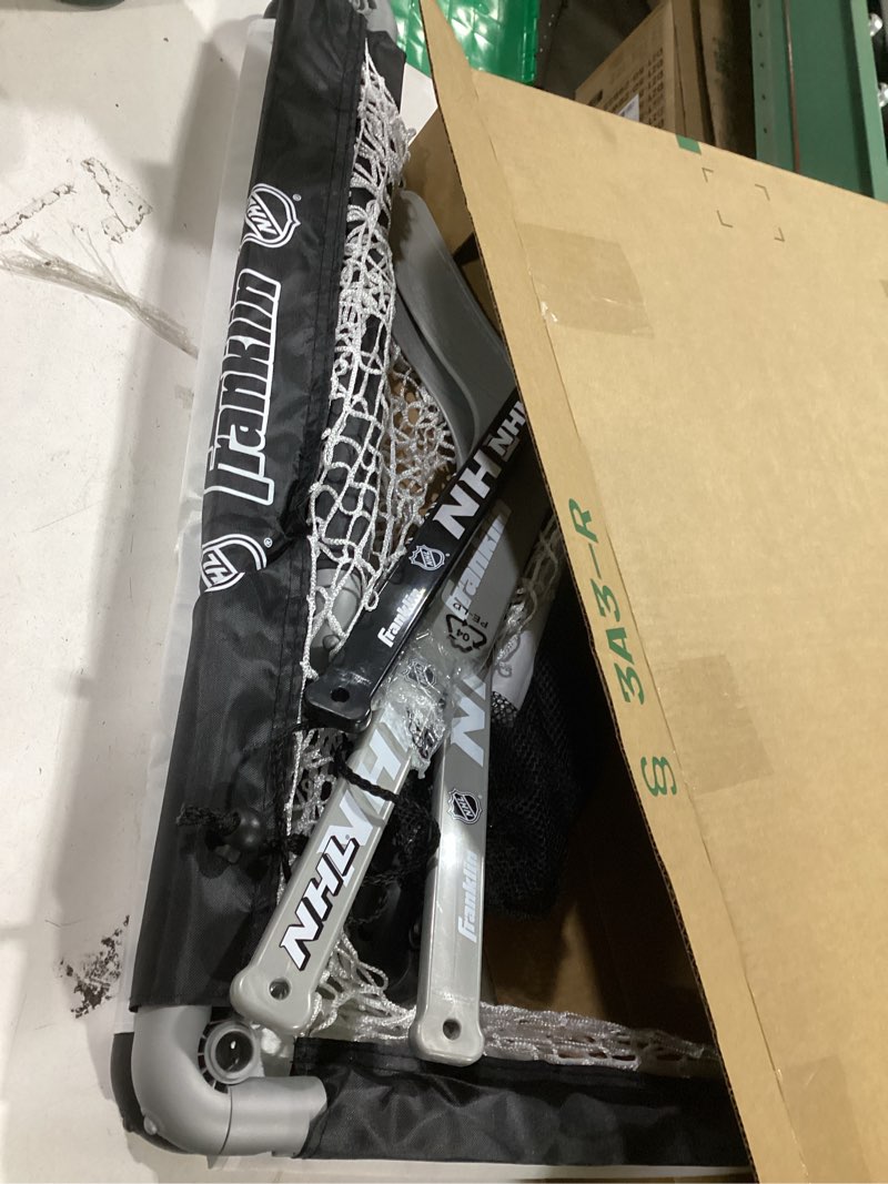 Condition photo showing As Is for franklin sports nhl kids mini hockey goal set - (2) mini + knee hockey goals, (4) youth sticks, (2) goalie sticks + (4) foam balls - knee + mini hockey set black one size