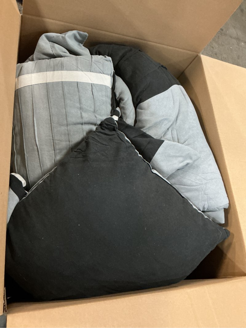 Condition photo showing As Is for Madison Park - Palmer 7 Piece Comforter Set - Black and Gray - California King - Pieced Microsuede - Includes 1 Comforter, 3 Decorative Pillows, 1 Bed Skirt, 2 Shams Black California King (104 in x 92 in)