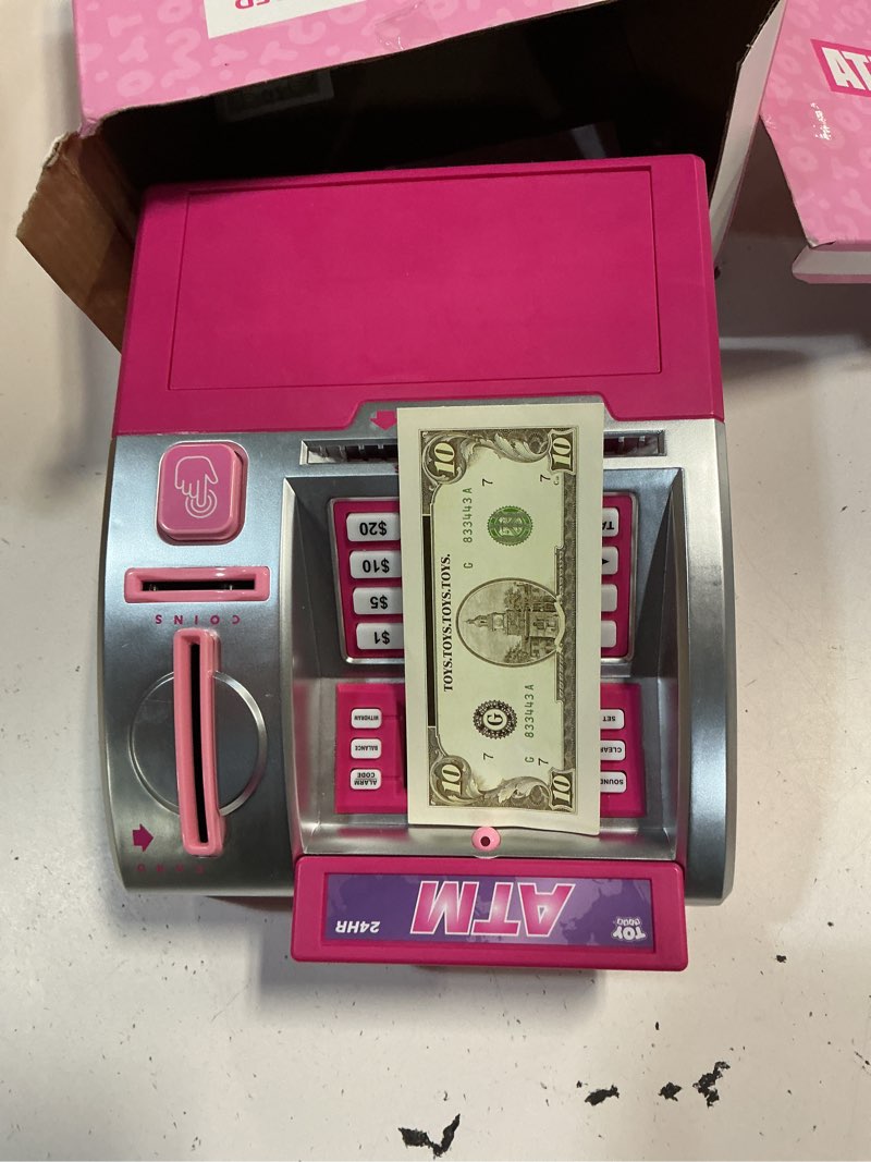 Condition photo showing As Is for pink piggy bank for kids, atm machine bank for real money with debit card, bill feeder, coin recognition, balance calculator, electronic savings safe box, gifts for teen boy girl