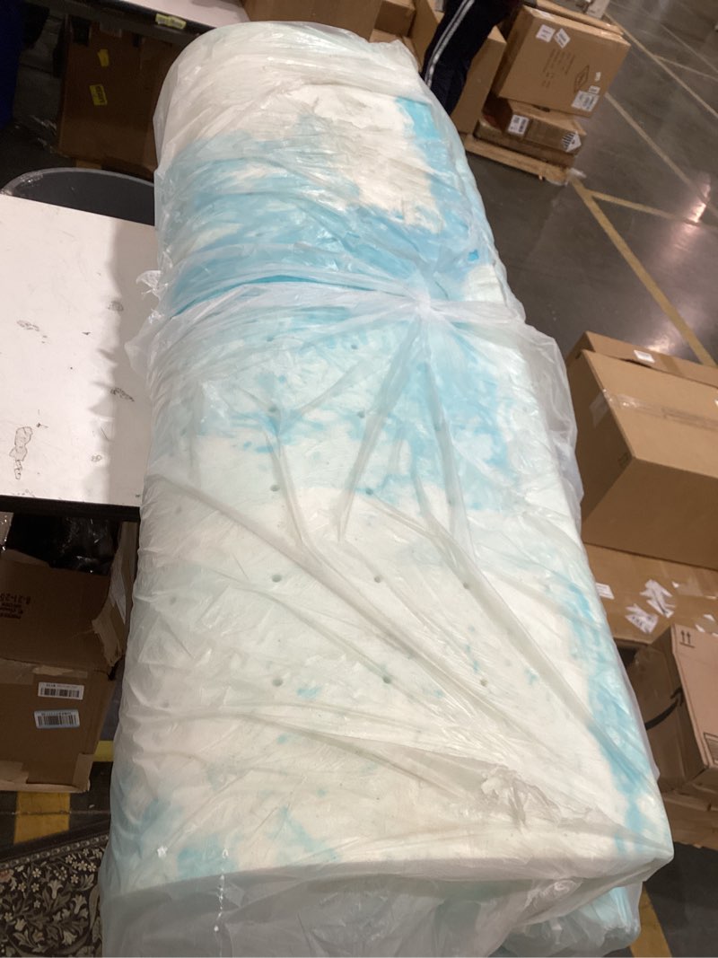 Condition photo showing As Is for this item is a rolled-up gel memory foam mattress topper, designed to add comfort and support to a mattress.  