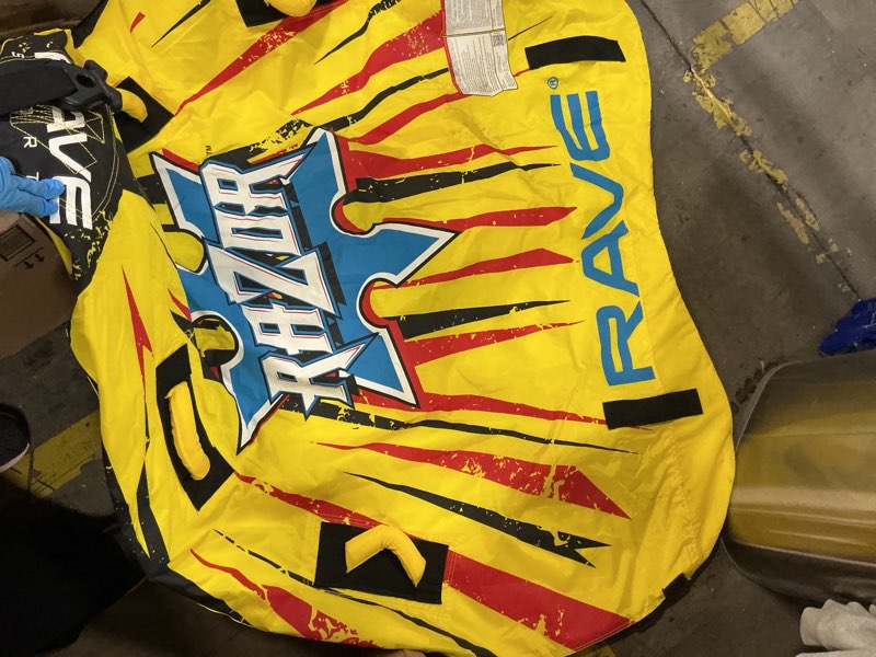 Condition photo showing As Is for RAVE Sports Razor Inflatable Towable Tube, 1-2 Riders, Unique Skim-Fast Bottom Coating, Nylon Cover, Four Foam-Filled Reinforced Handles, Quick Connect Tow Point, Boat Tubes and Towables