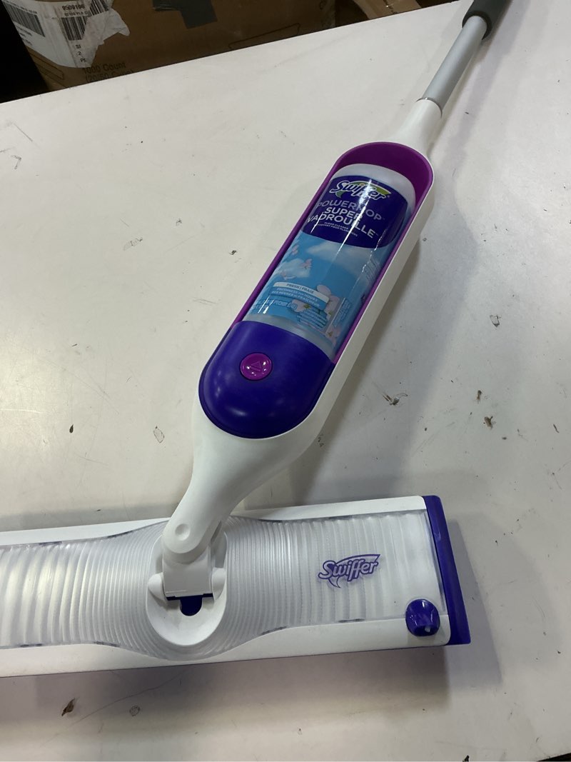 Condition photo showing As Is for swiffer powermop multi-surface mop kit for floor cleaning, includes powermop, 2 mopping pad refills, 1 cleaning solution with fresh scent and 2 batteries purple and white