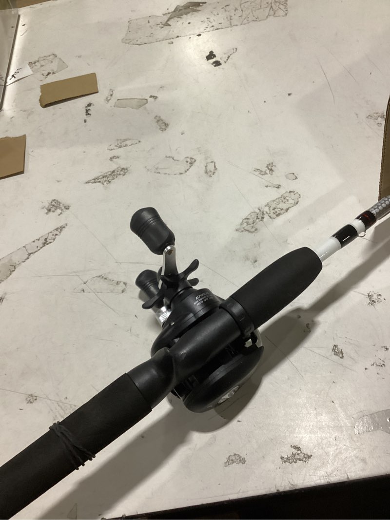 Condition photo showing As Is for shakespeare alpha medium 6' low profile fishing rod and bait cast reel combo (2 piece),black, white