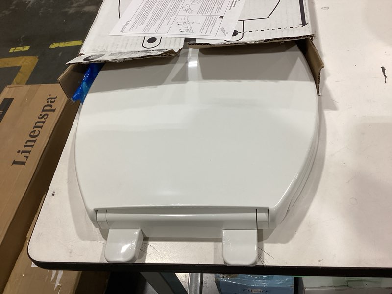 Condition photo showing As Is for kohler 20110-0 brevia, slow close toilet seat, elongated toilet seat, grip-tight bumpers quick-attach hardware, white white elongated quiet-close