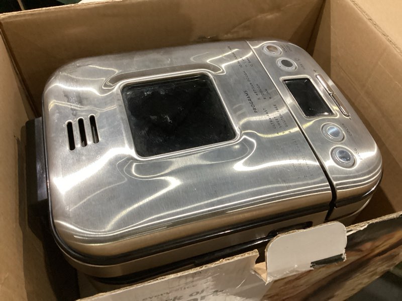 Condition photo showing As Is for cuisinart bread maker machine, stainless steel automatic bread machine with 12 menu options, 3 loaf sizes up to 2 lb., 3 crust colors, removable nonstick baking pan & kneading paddle, cbk-110nas