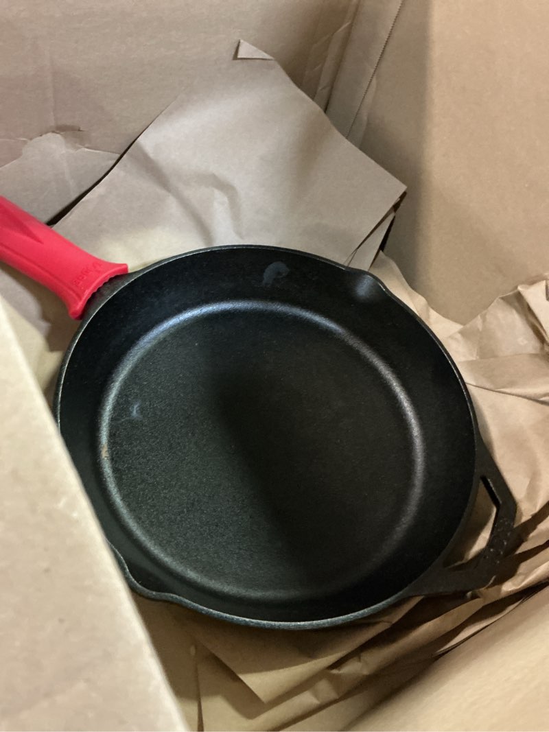 Condition photo showing As Is for Lodge Seasoned Cast Iron Skillet - Quality Frying Pan for the Stove, Oven, Grill & Campfire - Includes Silicone Hot Handle Holder - Non-Toxic, Nonstick & Long-Lasting - 12 Inches