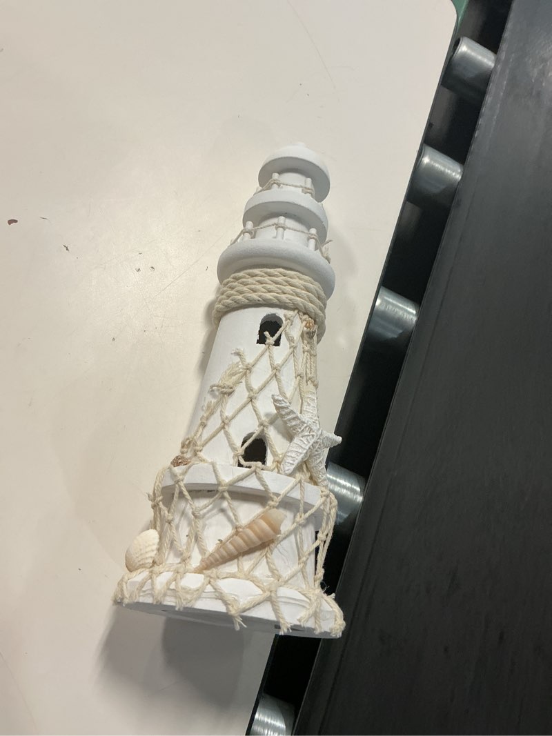 Condition photo showing New/Like New for puzzled white wooden lighthouse decor - handcrafted nautical lighthouse table top decor, lighthouse sea decorations for home with small starfish nautical net, and seashell ocean trinkets - 11 inches