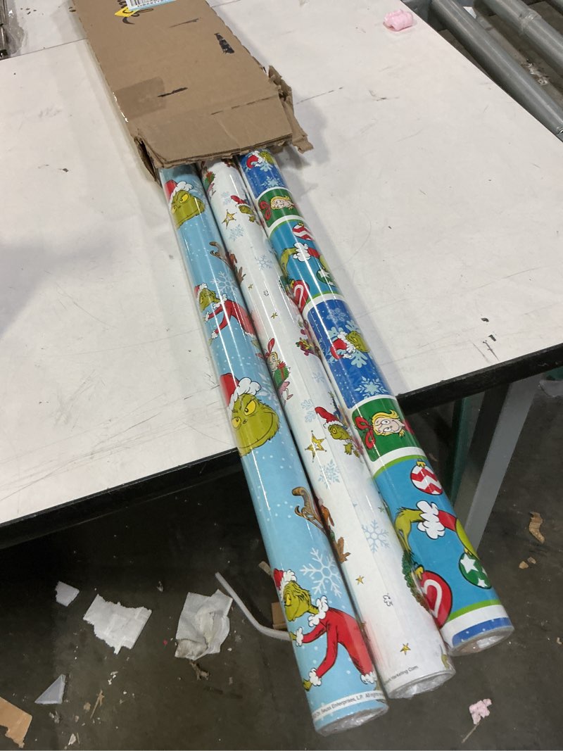 Condition photo showing New/Like New for hallmark dr. seuss grinch wrapping paper for kids (3 rolls: 105 sq. ft. ttl) for christmas with blue tiles, white snowflakes, cindy lou who, max