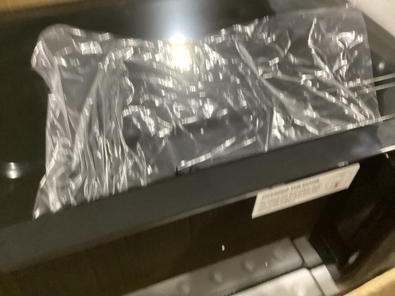 Condition photo showing As Is for chefman countertop microwave oven 0.7 cu. ft., 700 watts with 10 power levels, 6 cooking presets with one-touch express cook, eco mode, child safety lock, & mute button - black