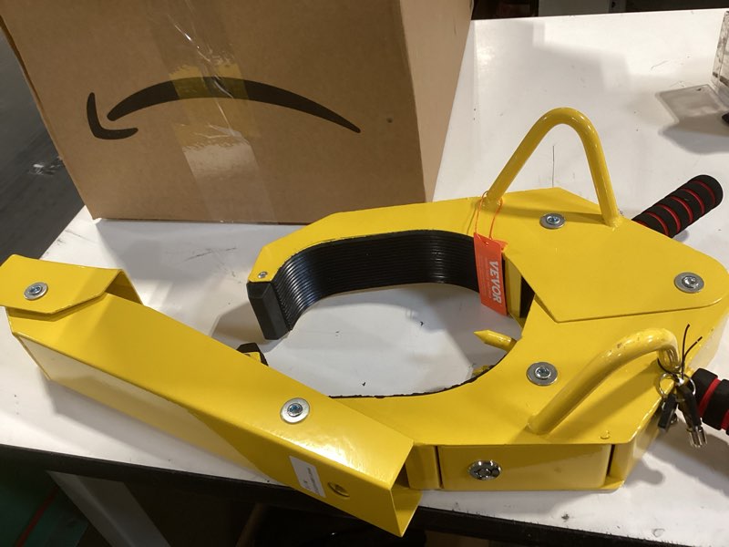 Condition photo showing As Is for turnart wheel lock, anti theft not only for wheels but also for rims, adjustable, universal, 3 keys, 1 crank, yellow