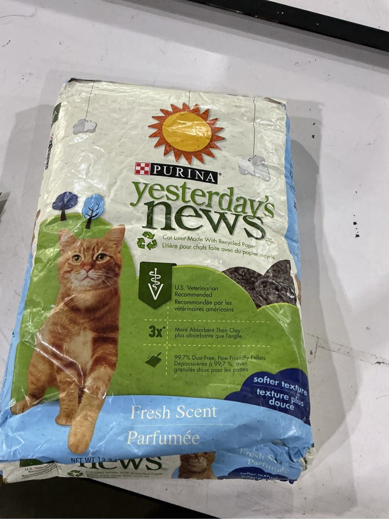 Condition photo showing New/Like New for the image shows a bag of purina yesterday's news softer texture fresh scent paper cat litter, featuring a ginger cat graphic and green accent labeling on a recycled paper formulation.