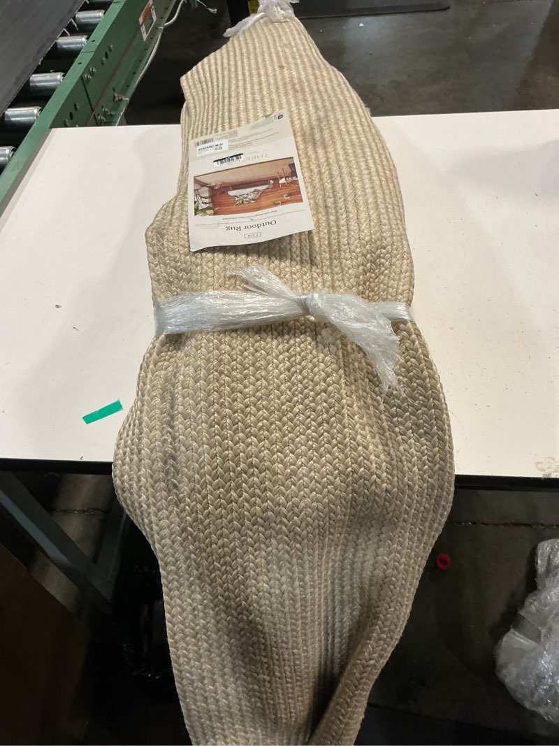 Condition photo showing As Is for 7'x10' natural woven rectangular braided outdoor area rug heathered cream - threshold ?