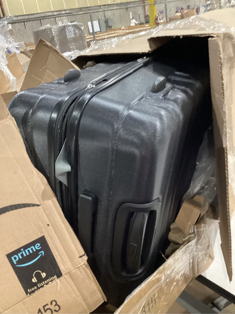 Condition photo showing As Is for amazon basics 26" hardside medium checked luggage, expandable for up to 15% more space, with scratch-resistant surface, four multi-directional wheels, black black medium checked