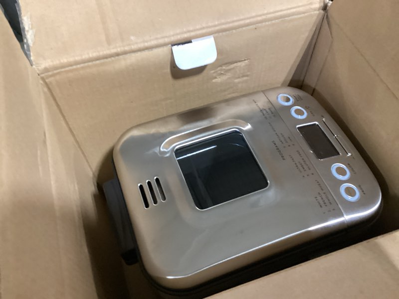 Condition photo showing As Is for cuisinart bread maker machine, stainless steel automatic bread machine with 12 menu options, 3 loaf sizes up to 2 lb., 3 crust colors, removable nonstick baking pan & kneading paddle, cbk-110nas