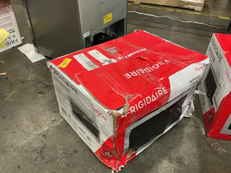 Condition photo showing As Is for Frigidaire EMW112OAMZ Stainless Steel Microwave Oven, Multi Function, Programmable, 1.1 Cu Ft 1000-Watt, residential kitchen, Stainless