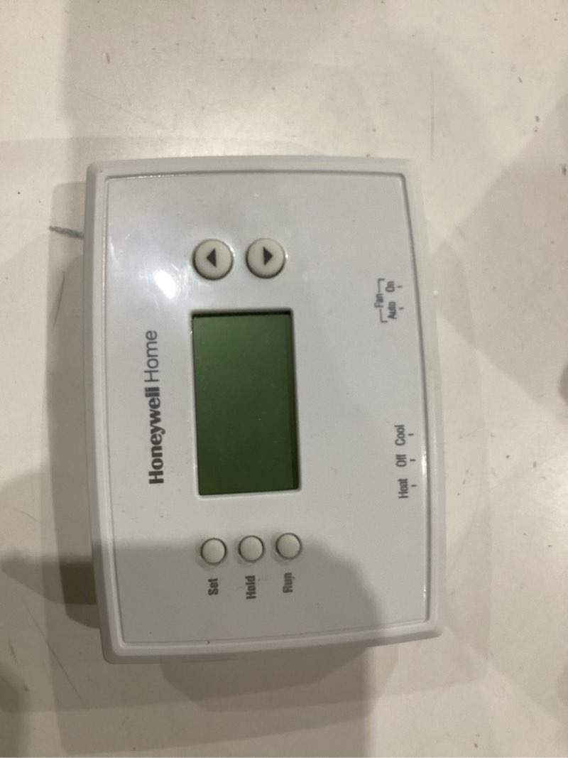 Condition photo showing As Is for Honeywell Home RTH2300B1038 5-2 Day Programmable Thermostat, White 2.50 L x 6.38 W x 7.94 H