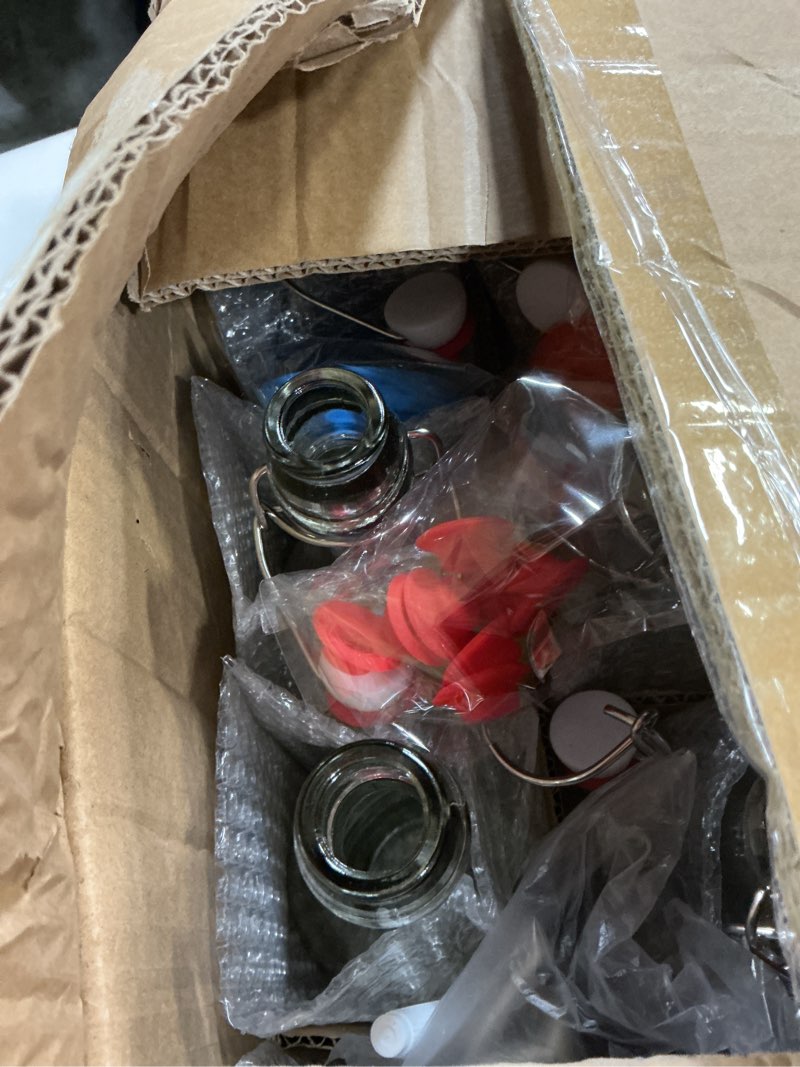 Condition photo showing New/Like New for 8 pack [1 l / 33 fl. oz.] swing top glass bottles w/ airtight stopper lids – flip top brewing bottle for fermentation, kombucha, mead, vinegar, beer, kefir, wine, soda – with 8 extra seals & 2 pourer