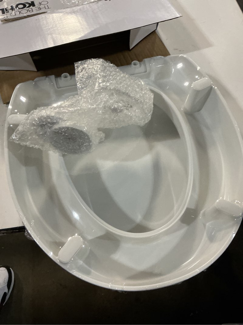 Condition photo showing New/Like New for kohler 25876-0 hyten 3" height, elevated soft close round toilet seat, contoured seat with grip-tight bumpers, quick-attach hardware, white white round