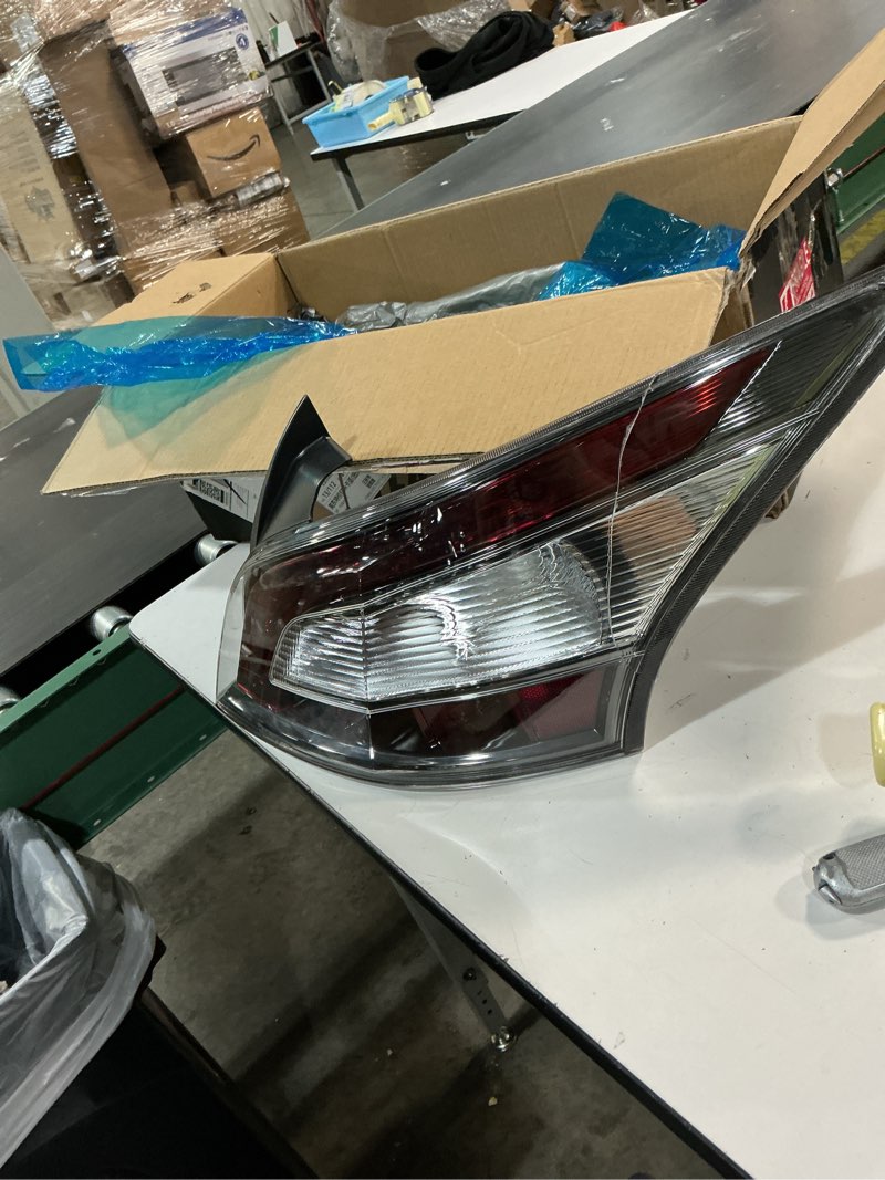 Condition photo showing As Is for garage-pro tail light assembly compatible with 2012-2014 nissan maxima with bulb driver side