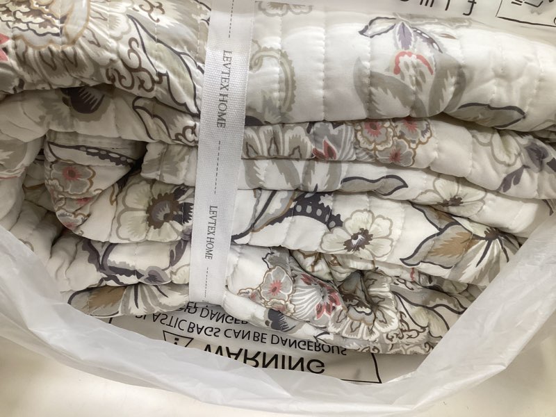 Condition photo showing As Is for levtex home - ophelia quilt set - king quilt and two king shams - floral - taupe grey cream blush - quilt (106x92in.) and shams (20x36in.) - reversible - rayon/cotton