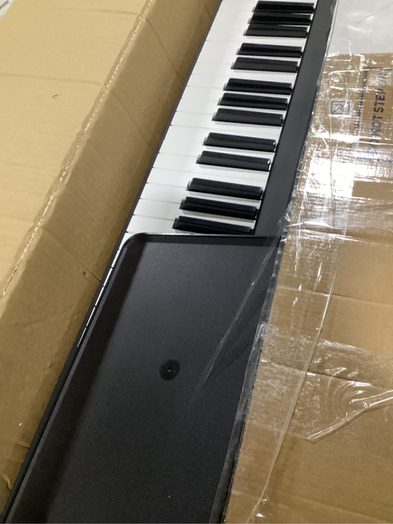 Condition photo showing Good Condition for amazon basics electric keyboard with 88-keys, semi-weighted digital piano with sustain pedal, power supply, 2 speakers, lesson mode, black
