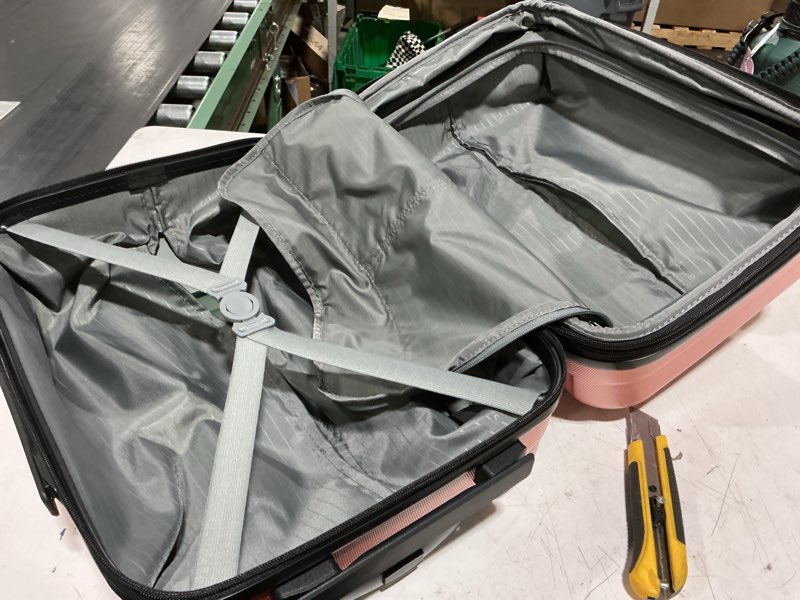 Condition photo showing As Is for amazon basics 21" hardside carry-on luggage with multi-directional wheels, expandable for up to 25% more space, scratch-resistant surface, rose gold rose gold carry-on