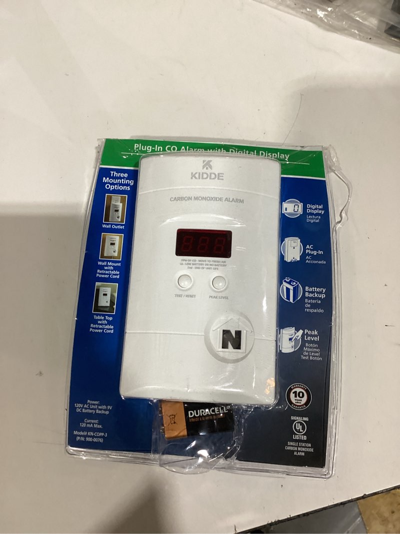 Condition photo showing As Is for kidde carbon monoxide detector, plug-in with 9v battery backup, digital display, 85 db alarm, led status light indicators, 3rd edition 1 pack 3rd edition