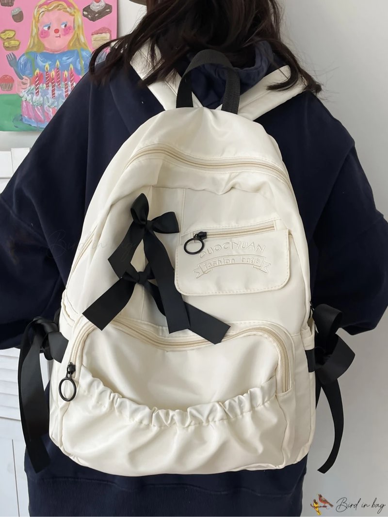Bird in Bag – Spacious and Waterproof Beige Backpack for Teen Girls, Women, and College Students – Ideal for School, College, and Back to School – Featuring Large Capacity, Lightweight Design, Classy Letter Graphic, Functional Bow Decor, and Convenient Zipper Closure