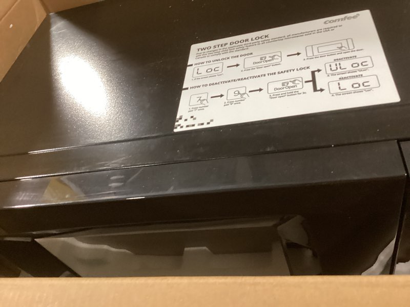 Condition photo showing As Is for comfee' em720cpl-pmb countertop microwave oven with sound on/off, eco mode and easy one-touch buttons, 0.7cu.ft, 700w, black