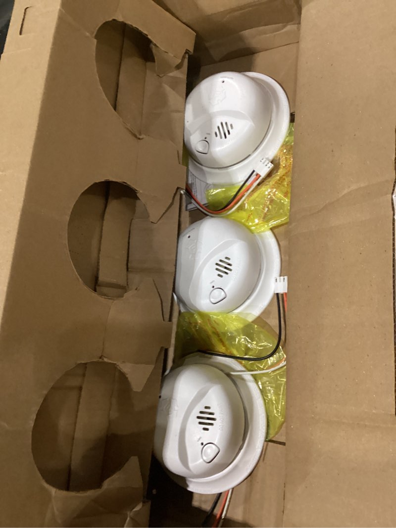 Condition photo showing As Is for first alert brk smoke alarm, interconnect hardwire detector with 10-year battery backup, smi105-ac, 3-pack precision detection smi105-ac 3-pack