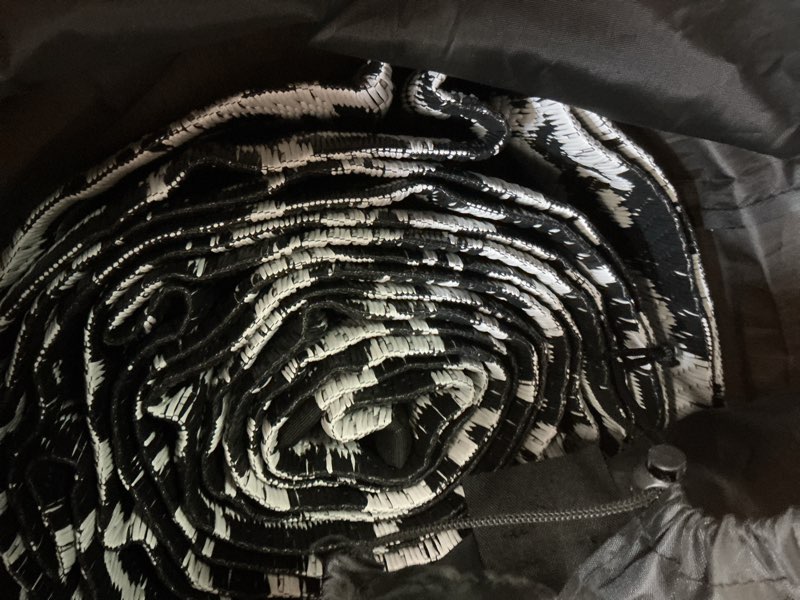Condition photo showing As Is for black and white plastic outdoor area rug 
