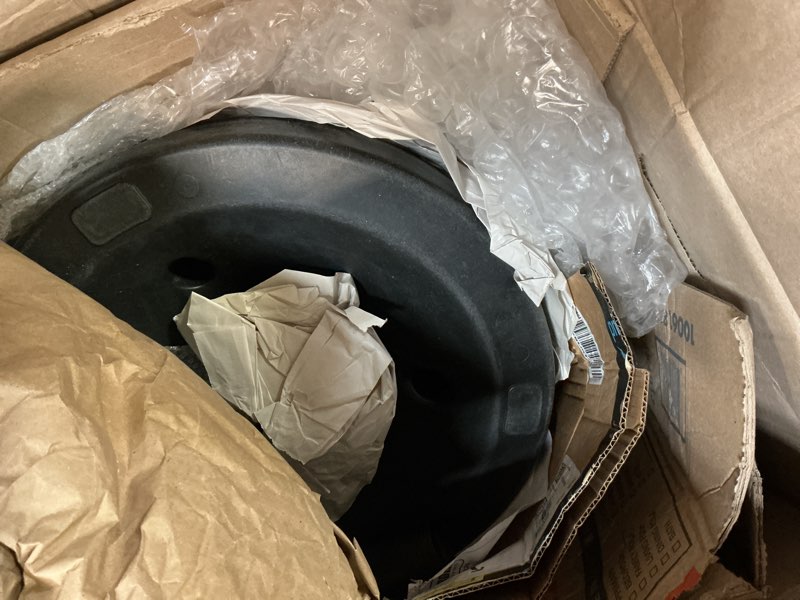 Condition photo showing As Is for Antique Bronze 40 lb Round Plastic and Concrete Patio Umbrella Stand Base