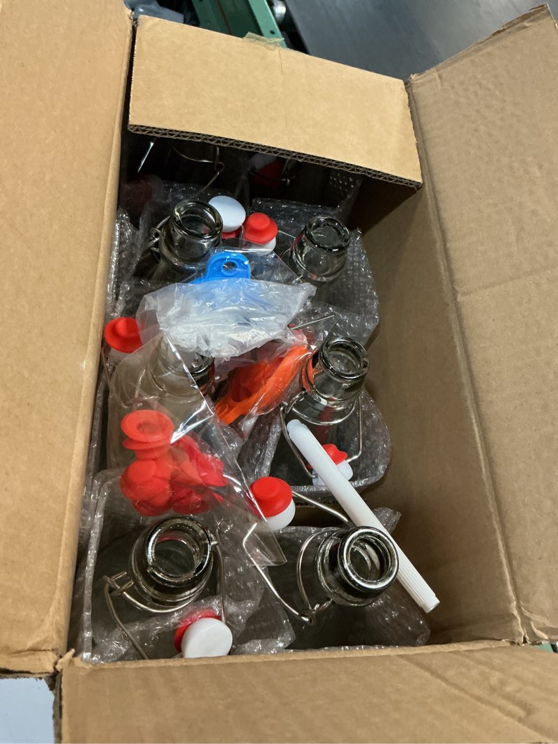 Condition photo showing New/Like New for 8 pack [1 l / 33 fl. oz.] swing top glass bottles w/ airtight stopper lids – flip top brewing bottle for fermentation, kombucha, mead, vinegar, beer, kefir, wine, soda – with 8 extra seals & 2 pourer