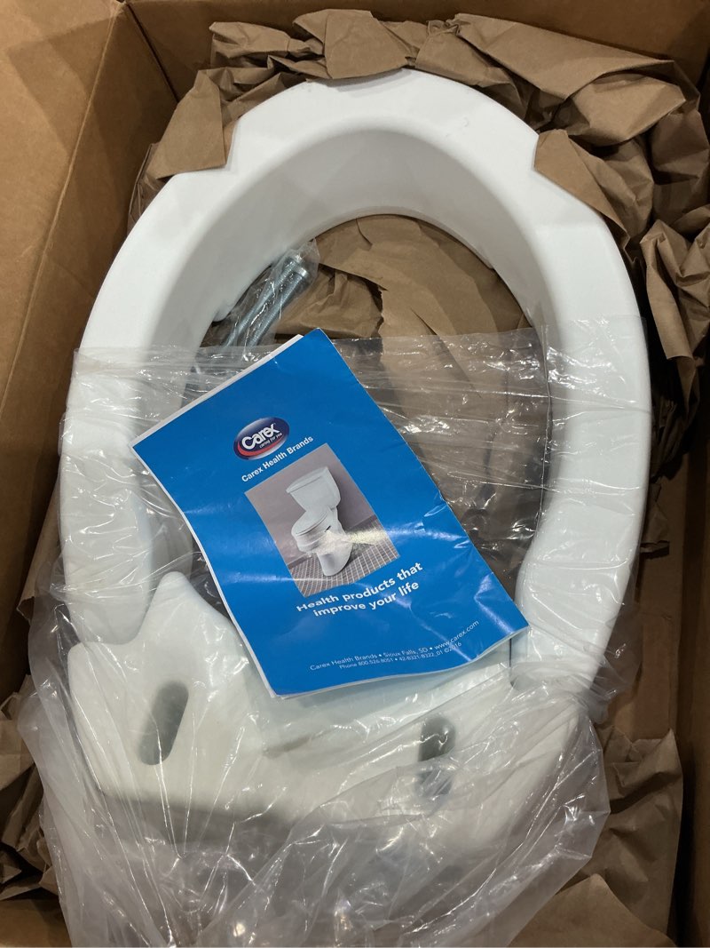 Condition photo showing As Is for carex elongated hinged toilet seat riser, adds 3.5 inches of height to toilet, 300 pound weight capacity, raised toilet seat