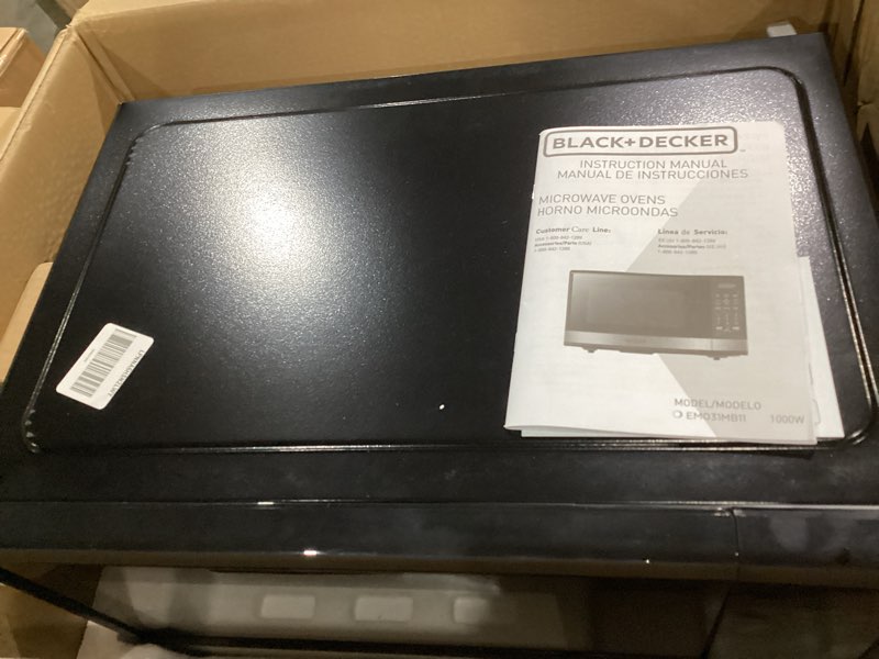 Condition photo showing As Is for black+decker em031mb11 digital microwave oven with turntable push-button door, child safety lock, 1000w, 1.1cu.ft, black & stainless steel, 1.1 cu.ft