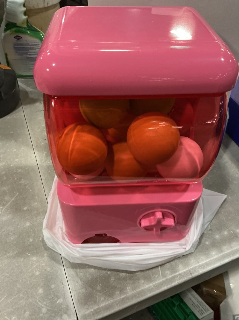 Condition photo showing New/Like New for mini gashapon machine, pink party toy dispenser with 21 reusable capsule balls, manual operation, 9 x 4 x 5.5 inches