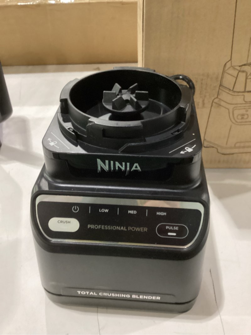 Condition photo showing As Is for used damaged on lid ninja br201amz professional blender 2.0, 1200 watts, auto-iq program, total crushing blades, 72-oz. pitcher, 4 manual speeds for smoothies, shakes, and frozen drinks, dishwasher-safe parts, dark grey generation 2 (1200 watts)