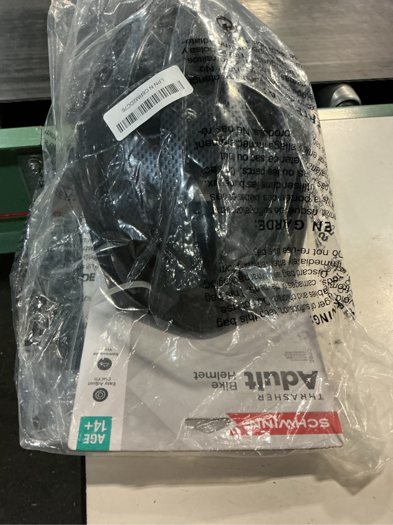 Condition photo showing New/Like New for schwinn thrasher helmet for adults, size 58-62 cm for riders ages 14+, microshell, adjustable dial & straps, interior padding, air vents, visor, adult bike helmet black non-lighted minimalist