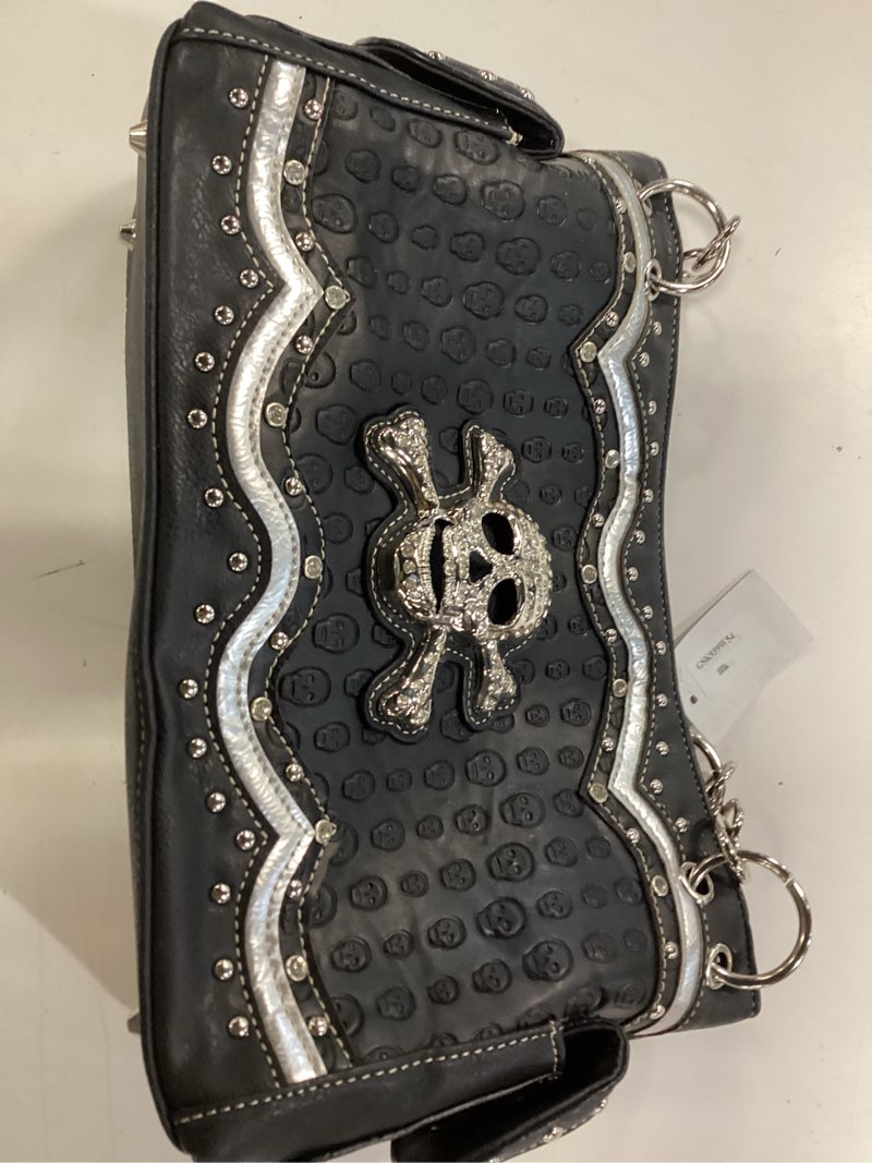 Condition photo showing New/Like New for black embossed skull shoulder bag features silver rhinestone details and chain handles