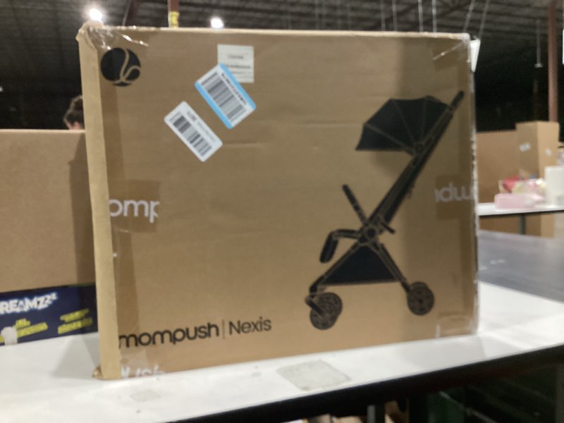 Condition photo showing New/Like New for Mompush Nexis Carbon Travel Stroller, Ultra-Lightweight 11.5 lbs, Compact & Airplane Carry-On Approved, One-Second Auto-Fold, One-Hand Full Recline, from Birth to 50 lbs, JPMA Certified Khaki