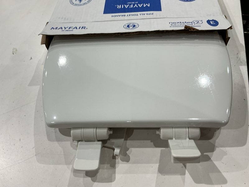 Condition photo showing As Is for mayfair by bemis nextstep2 wood white elongated soft close toilet seat