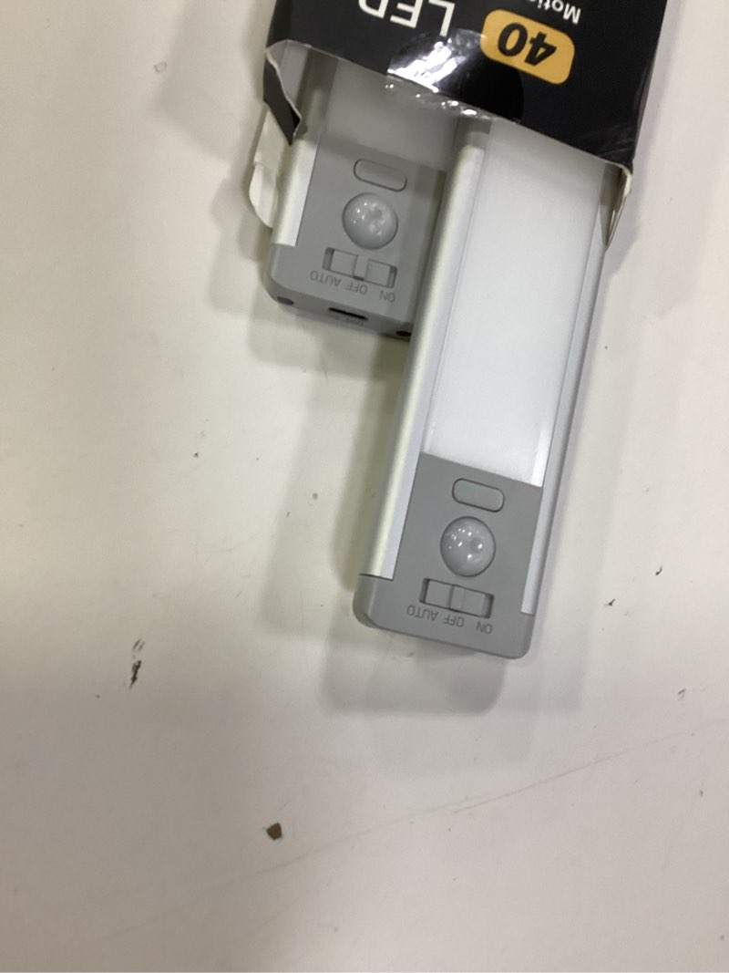 Condition photo showing As Is for 10inch under cabinet lighting, 2 pack rechargeable motion sensor light indoor, 5 levels dimmable magnetic closet lights, wireless under counter lights for kitchen, stairs warm white light 10inch