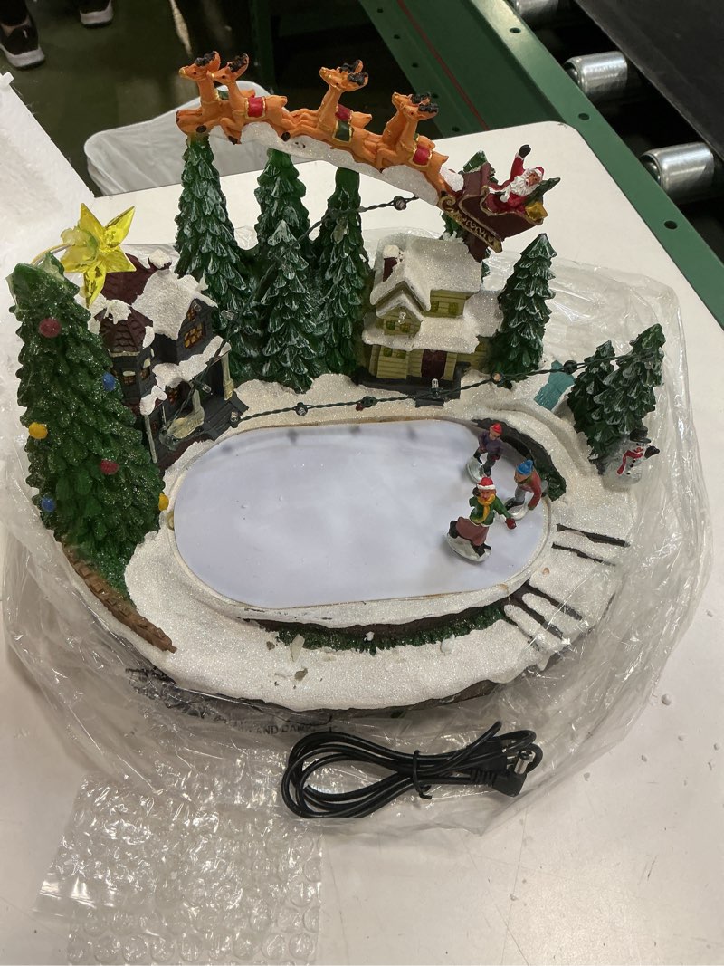 Condition photo showing Good Condition for Christmas Village Ice Skating Rink Animated Decorations, Lighted Musical Winter Snow Village Building Figurine with Christmas Tree and Skaters, LED Light Up Holiday Indoor Town Decor Skiing