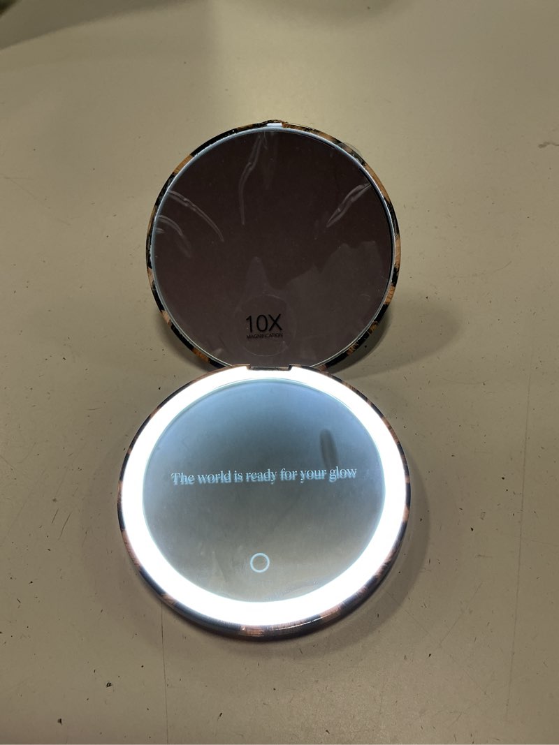 Condition photo showing New/Like New for fancii mini taylor compact magnifying mirror with led light, 10x/1x, rechargeable, 3 light settings, dimmable-small lighted travel handheld mirror for pocket, handbag, purse, 2-sided (cheetah chic)