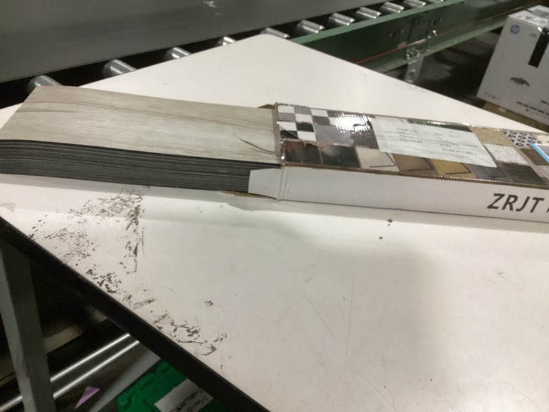 Condition photo showing As Is for 54 Sq.Ft. Peel and Stick Vinyl Floor Tiles 36" x 6" Wood Look Planks, 36 Pack Waterproof Self-Adhesive Flooring Tiles, DIY for Renter, Kitchen, Living Room, RV, Washed White