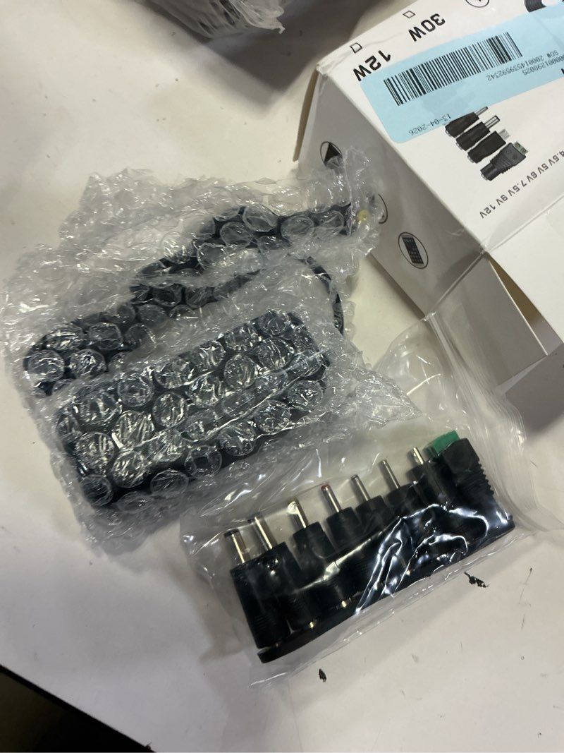 Condition photo showing New/Like New for universal ac/dc adapter multi-voltage regulated switching power supply with 8 selectable dc plugs for 3v 4.5v 5v 6v 7.5v 9v 12v household electronics