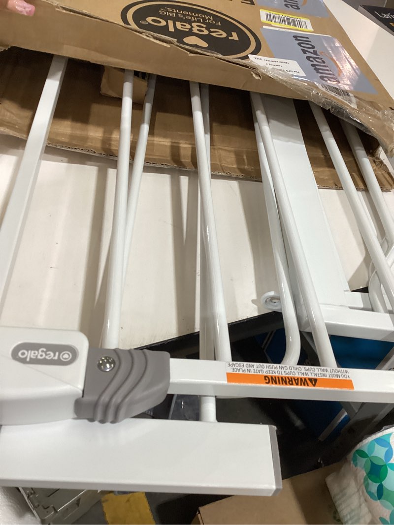 Condition photo showing As Is for regalo safety 29-38.5" baby gate for doorways & bottom of stairs, pressure mounted baby gate with door for babies, toddlers & pets, tested & safe for 30 years, american designed, american owned, white white 29-38.5"w x 30"h