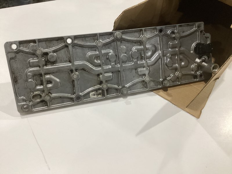 Condition photo showing As Is for gm genuine parts 12698755 valve lifter oil manifold with solenoid, gasket, filter, retainer, bolts, and cap